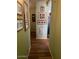 Hallway featuring wood flooring and Gathering photos on a light green wall at 40047 N Cassara Dr, San Tan Valley, AZ 85140