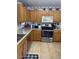 A bright kitchen with stainless steel appliances and tan cabinets at 40047 N Cassara Dr, San Tan Valley, AZ 85140