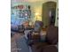 Inviting living room area featuring comfortable seating and a wall decorated with Gathering photos at 40047 N Cassara Dr, San Tan Valley, AZ 85140