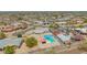 View of a home and backyard featuring a private pool and neighborhood homes at 405 E Thunderbird Trl, Phoenix, AZ 85042