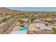 View of a home and backyard featuring a private pool and neighborhood homes at 405 E Thunderbird Trl, Phoenix, AZ 85042