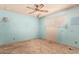 Bedroom with ceiling fan, window, and visible wall damage and carpet wear at 405 E Thunderbird Trl, Phoenix, AZ 85042