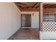 Covered front porch features lattice details and vintage fixtures at 405 E Thunderbird Trl, Phoenix, AZ 85042