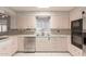Well-lit kitchen with stainless steel appliances and a classic design at 405 E Thunderbird Trl, Phoenix, AZ 85042
