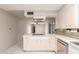Functional kitchen with open layout, stainless steel appliances, and tile flooring at 405 E Thunderbird Trl, Phoenix, AZ 85042