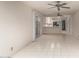 Bright living room with tile flooring connecting to an open kitchen at 405 E Thunderbird Trl, Phoenix, AZ 85042
