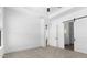 Bedroom with carpet and ensuite bathroom with a sliding barn door at 4451 N 203Rd Ave, Buckeye, AZ 85396