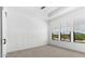 Empty bedroom with plush carpeting and natural light at 4451 N 203Rd Ave, Buckeye, AZ 85396