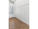 Bright entryway featuring wood floors, board and batten wainscoting, and a glass paneled front door at 4451 N 203Rd Ave, Buckeye, AZ 85396