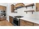 Well-appointed kitchen showcases stainless steel appliances, custom cabinets, and a white countertop at 4451 N 203Rd Ave, Buckeye, AZ 85396