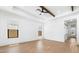 Bright living room featuring wood-look tile flooring and coffered ceilings at 4451 N 203Rd Ave, Buckeye, AZ 85396