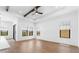 Spacious living room with wood-look flooring, coffered ceilings, recessed lighting, and lots of windows at 4451 N 203Rd Ave, Buckeye, AZ 85396