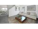 Bright living room featuring a modern sofa and stylish decor with a decorative coffee table at 47204 W Coe St, Maricopa, AZ 85139