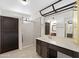 Bright bathroom featuring a walk-in shower, updated vanity with lots of storage and decorative mirror at 4790 E Navajo St, Phoenix, AZ 85044
