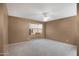 A carpeted bedroom with a modern ceiling fan, bay window and neutral paint at 4790 E Navajo St, Phoenix, AZ 85044