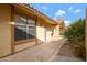 A walkway lined with landscaping along the side of a light colored single-story home with a terra cotta roof at 4790 E Navajo St, Phoenix, AZ 85044