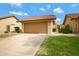 Exterior shot of a home featuring a terra cotta roof, two-car garage, walkway and verdant lawn at 4790 E Navajo St, Phoenix, AZ 85044