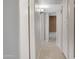 Bright hallway featuring neutral tones, tile flooring, and access to multiple rooms at 4790 E Navajo St, Phoenix, AZ 85044