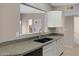 Kitchen pass-through features a granite countertop, undermount sink and white cabinets at 4790 E Navajo St, Phoenix, AZ 85044