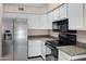 Bright kitchen with white cabinets, granite countertops, and stainless steel appliances at 4790 E Navajo St, Phoenix, AZ 85044