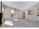 A spacious living room featuring neutral paint, plush carpet, a fireplace, and views through many windows at 4790 E Navajo St, Phoenix, AZ 85044