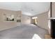 A spacious living room featuring neutral paint, plush carpet, a fireplace, and a chandelier at 4790 E Navajo St, Phoenix, AZ 85044