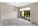 Bright living room features neutral walls, grey carpet, and sliding glass doors to the patio at 4790 E Navajo St, Phoenix, AZ 85044