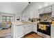 Modern kitchen featuring white cabinets, sleek appliances, and an open view to the living area at 4901 E Kelton Ln # 1270, Scottsdale, AZ 85254