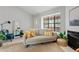 Bright living area featuring a gray sofa, decorative fireplace and a view of the entry at 4901 E Kelton Ln # 1270, Scottsdale, AZ 85254