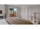 Main bedroom with an exterior door, a large closet, a cat tree, and soft, light-colored carpet at 4901 E Kelton Ln # 1270, Scottsdale, AZ 85254