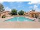 Community pool featuring trees and tile-roofed buildings in the background at 4901 E Kelton Ln # 1270, Scottsdale, AZ 85254