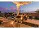 This covered outdoor kitchen with grill and a swimming pool provides the perfect space for entertainment at 5218 N Tiller Dr, Litchfield Park, AZ 85340