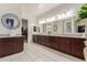 Large bathroom featuring dual sinks, granite countertops, and generous storage space at 5218 N Tiller Dr, Litchfield Park, AZ 85340