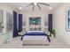 Well-lit bedroom featuring a ceiling fan, neutral tones, and comfortable furnishings at 5218 N Tiller Dr, Litchfield Park, AZ 85340