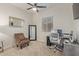 Well lit bedroom featuring a comfortable office space and plush carpet at 5218 N Tiller Dr, Litchfield Park, AZ 85340
