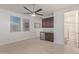 Bonus room featuring a ceiling fan, wet bar and access to a bathroom at 5218 N Tiller Dr, Litchfield Park, AZ 85340