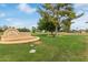 Park sign in a lush park setting with shade trees and picnic tables at 5218 N Tiller Dr, Litchfield Park, AZ 85340