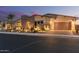 Inviting exterior of a single-story home with stone accents and a convenient two-car garage at 5218 N Tiller Dr, Litchfield Park, AZ 85340