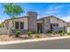 Attractive single-story home featuring stone details, desert landscaping, and meticulous design at 5218 N Tiller Dr, Litchfield Park, AZ 85340