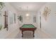 Bright game room with a pool table under a modern light fixture, art decorations, and light walls at 5218 N Tiller Dr, Litchfield Park, AZ 85340
