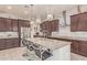 Open kitchen featuring a large island, breakfast bar, stainless steel appliances, and granite countertops at 5218 N Tiller Dr, Litchfield Park, AZ 85340
