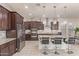 Beautiful open kitchen with granite counters, large island, stainless steel appliances, and tile floors at 5218 N Tiller Dr, Litchfield Park, AZ 85340