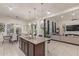 Open concept kitchen with a large island, stainless steel appliances, and modern lighting fixtures at 5218 N Tiller Dr, Litchfield Park, AZ 85340