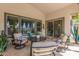Comfortable outdoor seating area with travertine tile and lush landscaping, perfect for relaxing at 5218 N Tiller Dr, Litchfield Park, AZ 85340