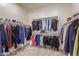 Spacious walk-in closet with ample hanging space and shelving for storage at 5218 N Tiller Dr, Litchfield Park, AZ 85340