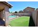 Fenced backyard with a pool and green turf at 537 S 153Rd Ln, Goodyear, AZ 85338
