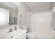 Bathroom featuring a sink, toilet, mirror and a shower-tub combo with curtain at 537 S 153Rd Ln, Goodyear, AZ 85338
