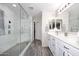Updated bathroom features double sinks, a walk-in shower, and modern fixtures at 537 S 153Rd Ln, Goodyear, AZ 85338