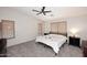 Carpeted bedroom with a cozy bed, black bedside dressers, and natural light from windows with blinds at 537 S 153Rd Ln, Goodyear, AZ 85338