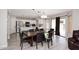 An open concept space with a large dining table, chairs, and sliding doors at 537 S 153Rd Ln, Goodyear, AZ 85338